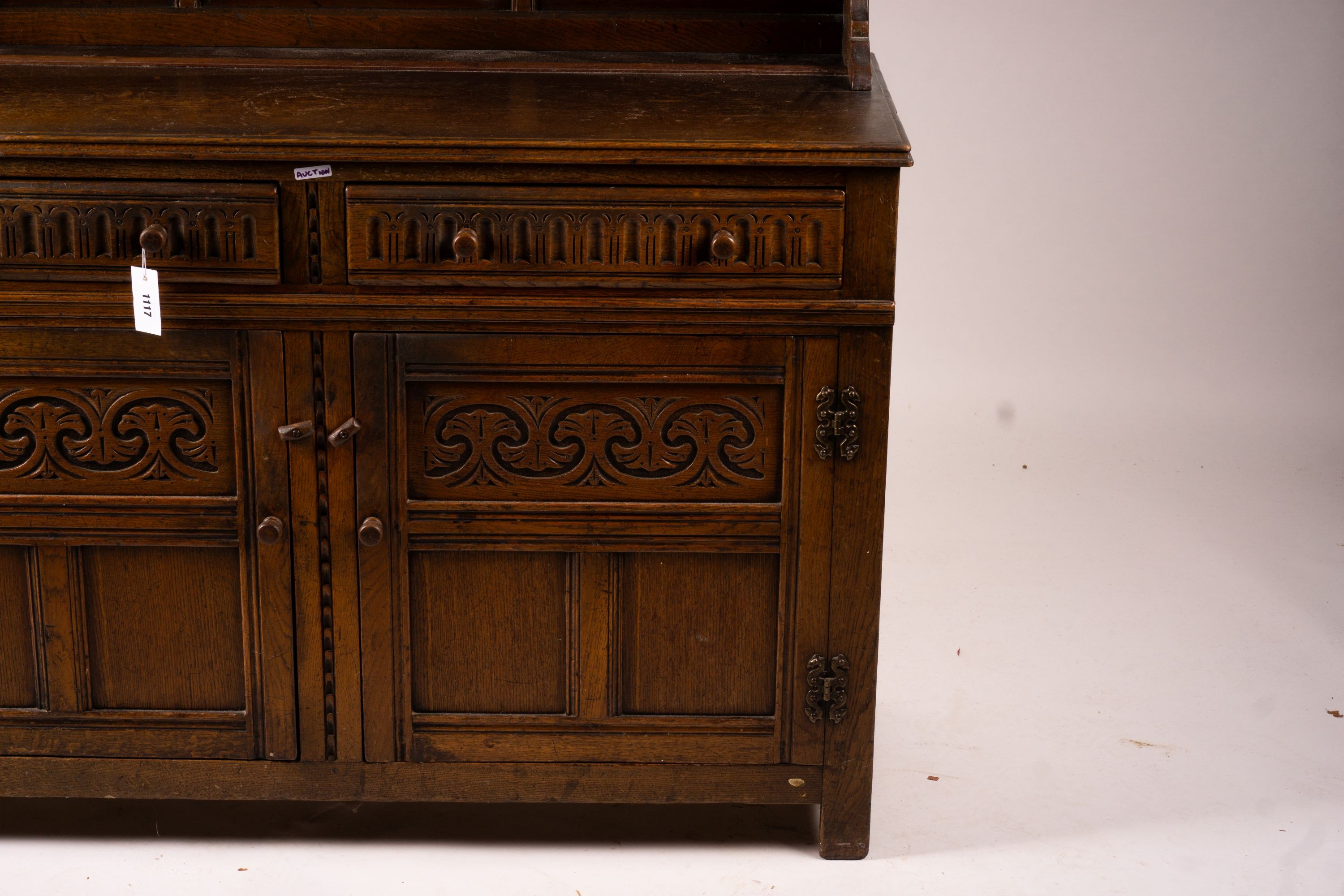 An 18th century style carved oak dresser, width 124cm, depth 46cm, height 175cm